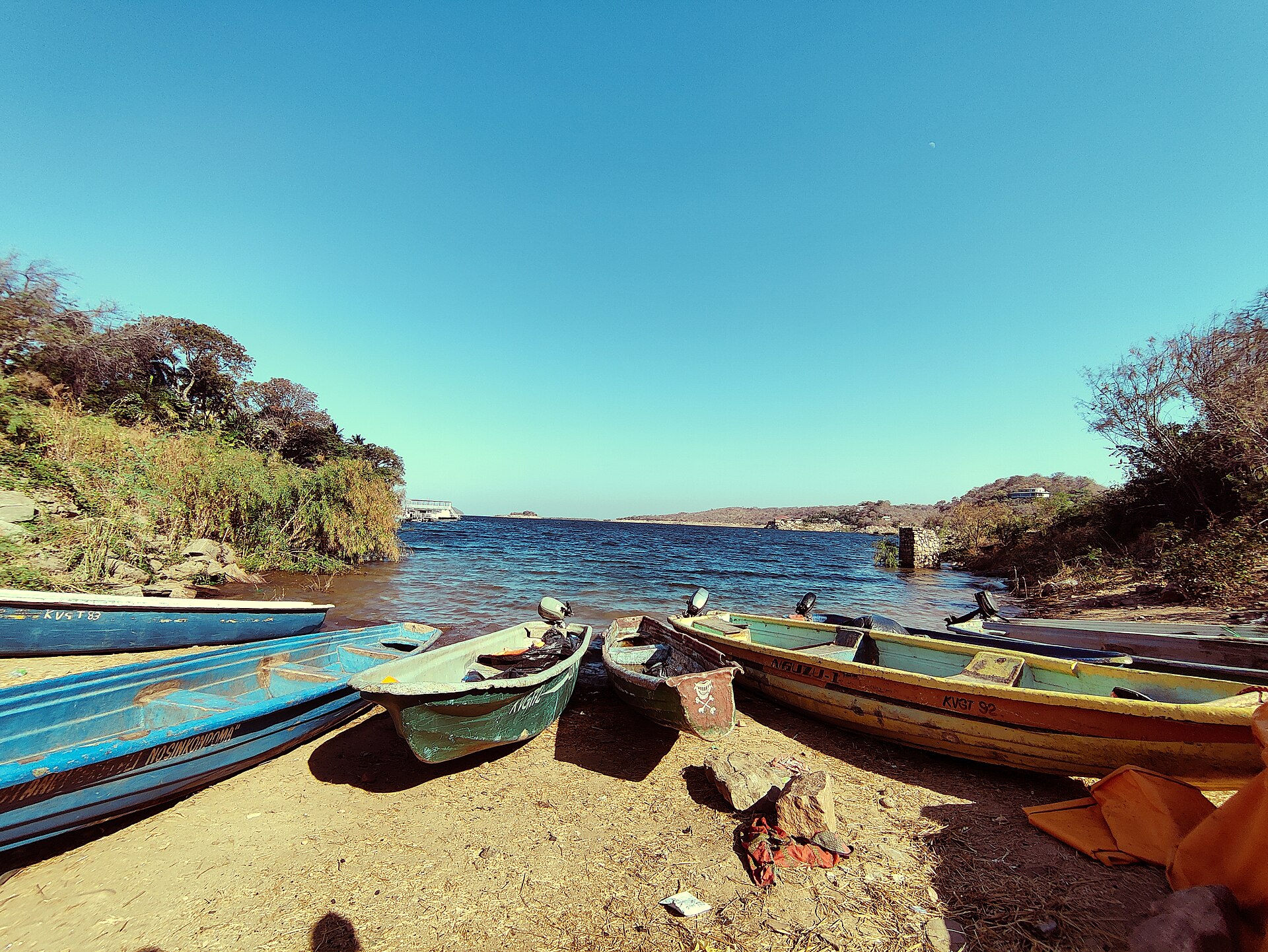 Fishing boats drawn up on the shore of Lake Kariba at Siavonga, Zambia, with the open lake behind them