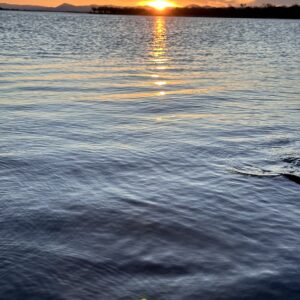 Sunset over the Zambezi River in Lower Zambezi National Park, Zambia, with the escarpment hills silhouetted behind