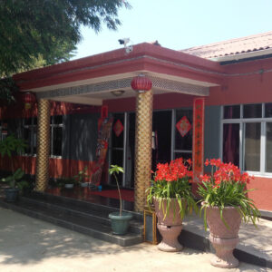 The red-painted entrance frontage of the Red Lantern Hotel in Lusaka, with gold pillars and hanging lanterns