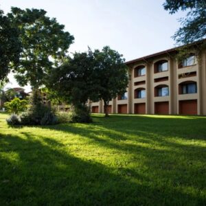 The arched two-storey guest wing and lawns at Mkango Golfview Hotel, Lusaka