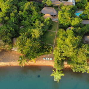 Aerial view of the thatched chalets and Lake Tanganyika beachfront at Ndole Bay Lodge