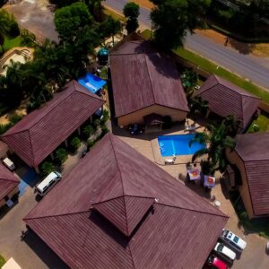 Aerial view of the red-tiled chalet roofs and swimming pool at Mika Lodge, Jesmondine, Lusaka