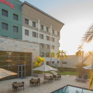The pool terrace and exterior signage at StayEasy Lusaka