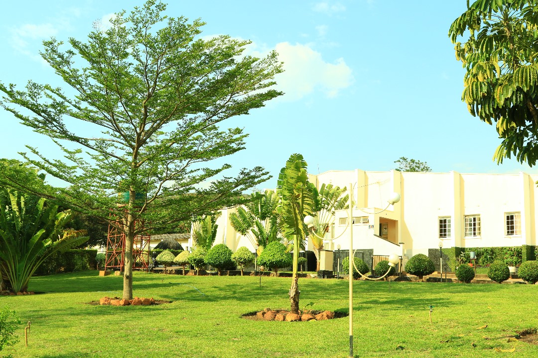 The lawned grounds and shade trees in front of the accommodation block at Crystal Springs Hotel, Chipata