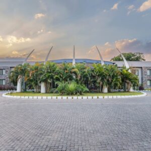 The low-rise wings and landscaped circular driveway of Protea Hotel by Marriott Ndola at dusk