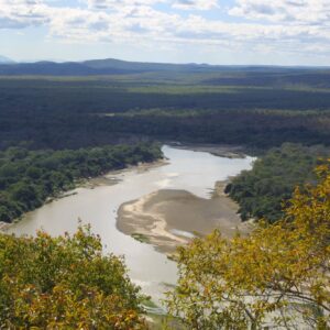 A wide bend of the Luangwa River between wooded banks in South Luangwa National Park. Context photograph of the area around Croc Valley Camp, not of the property itself.