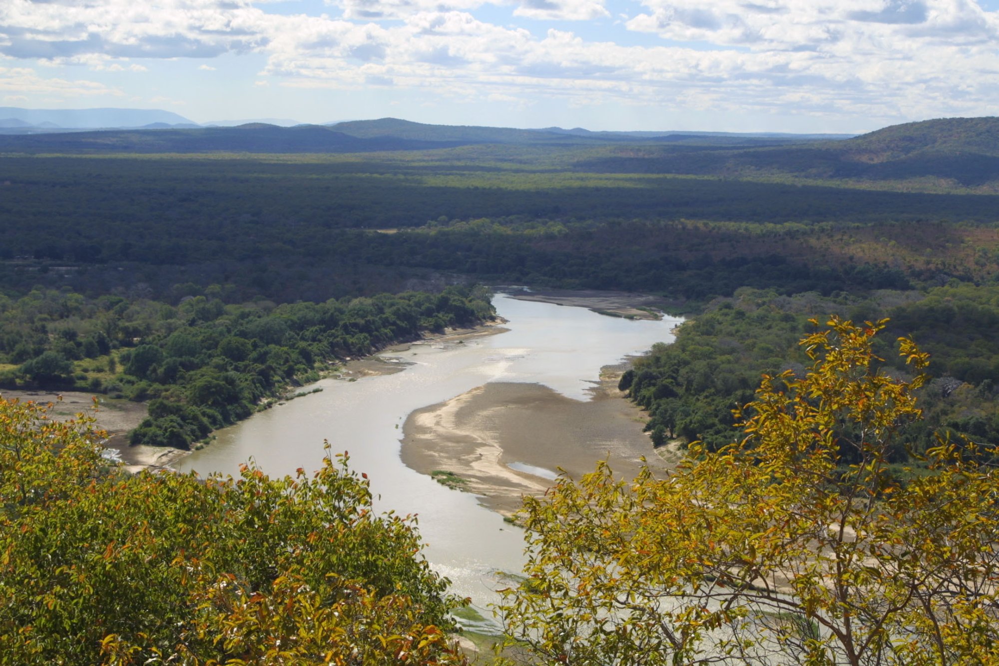 A wide bend of the Luangwa River between wooded banks in South Luangwa National Park. Context photograph of the area around Croc Valley Camp, not of the property itself.